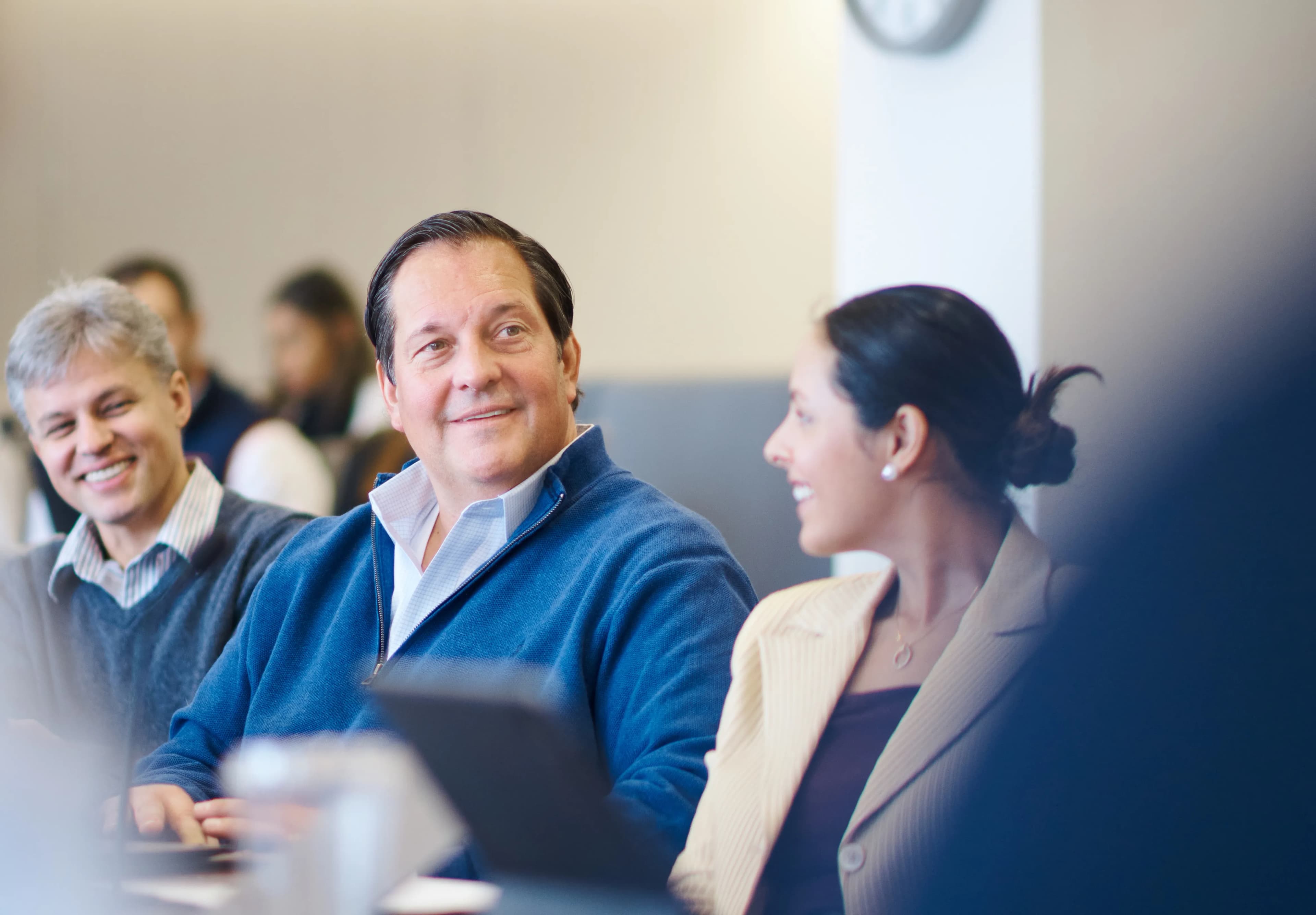 man and woman smiling at desk